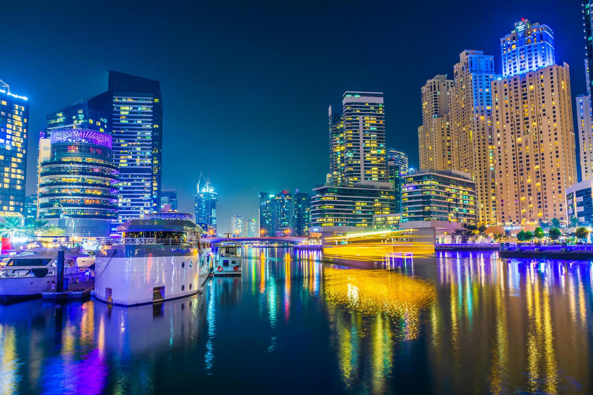 Global Village illuminated at night with crowds and lights