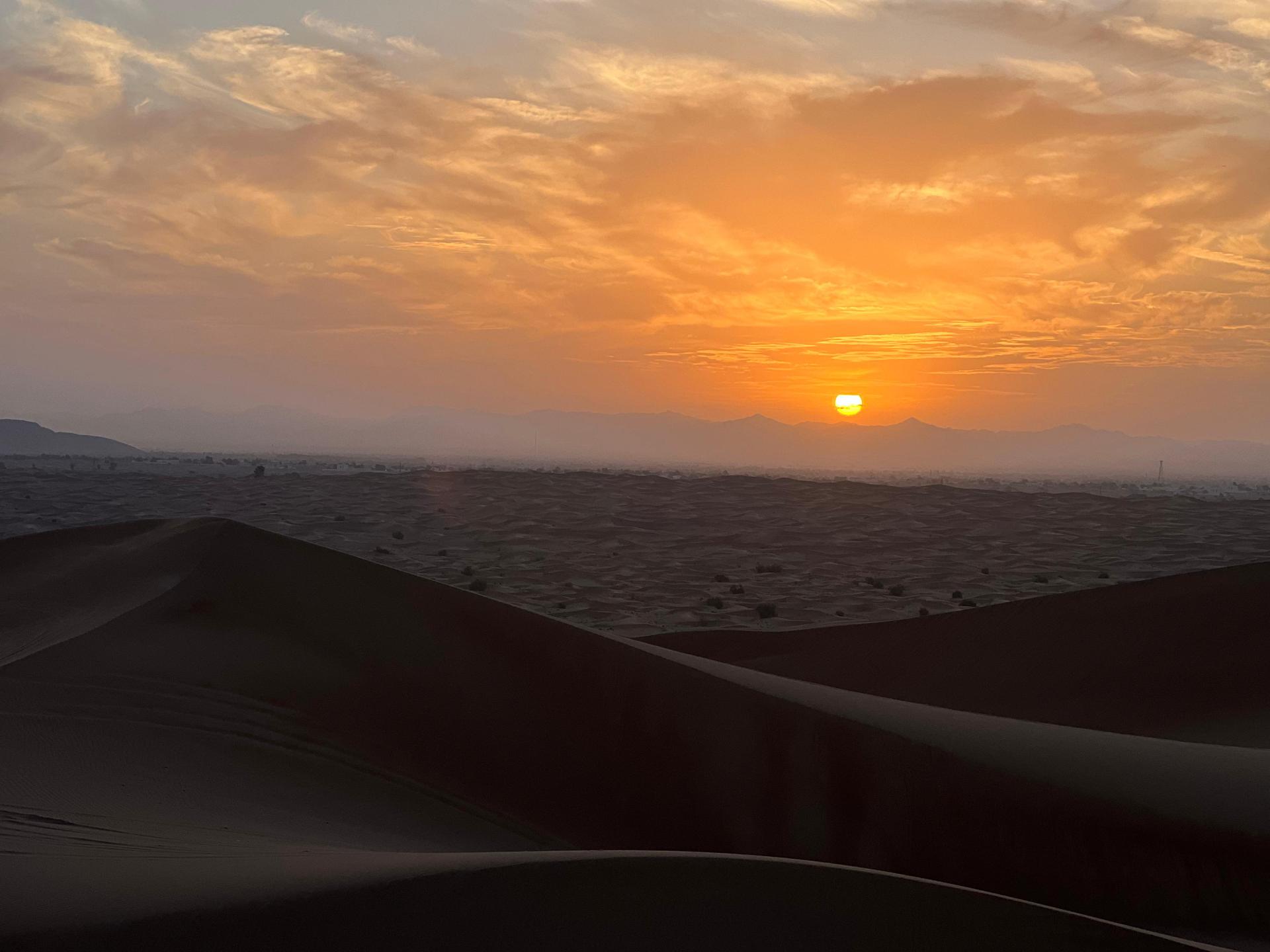 Golden sunrise view from sand dunes during Dubai morning safari