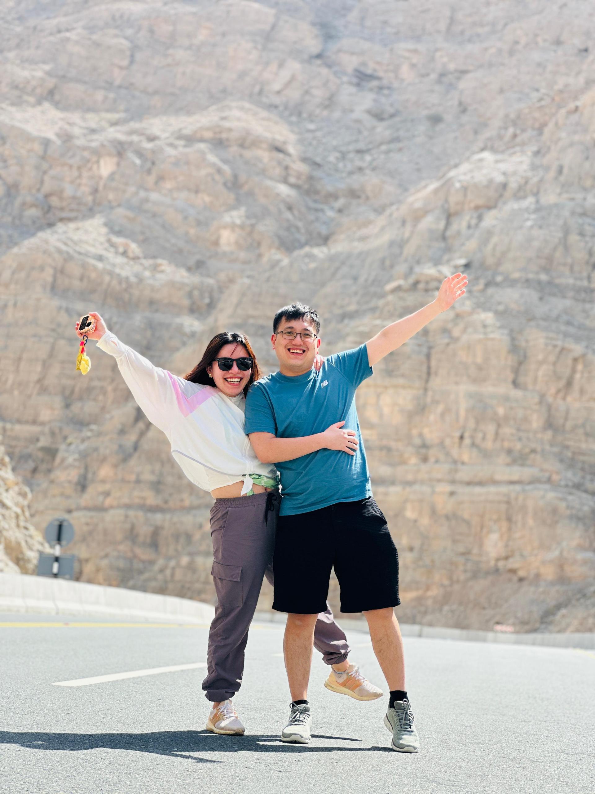 Tourists at Jebel Jais viewing platform with mountain backdrop