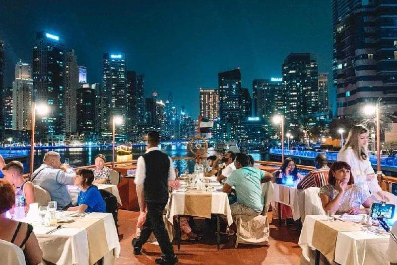 Guests enjoying buffet dinner inside Al Mansour dhow cruise Dubai