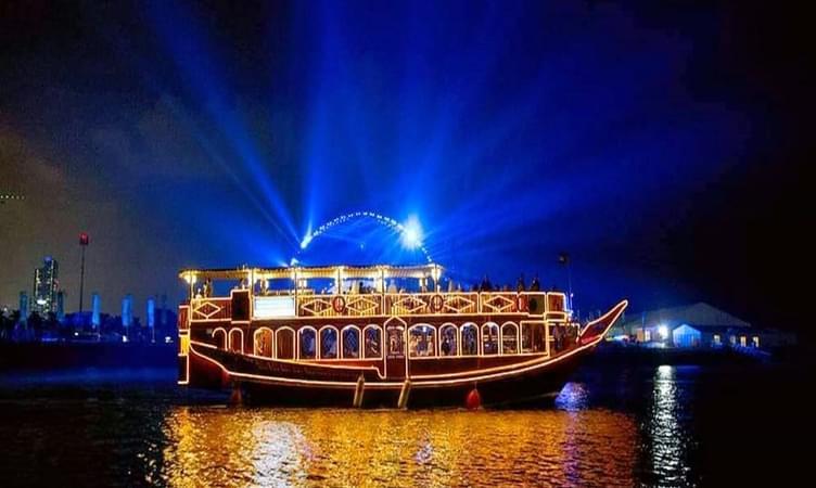 Dubai Marina waterfront lit up at night during dhow dinner cruise