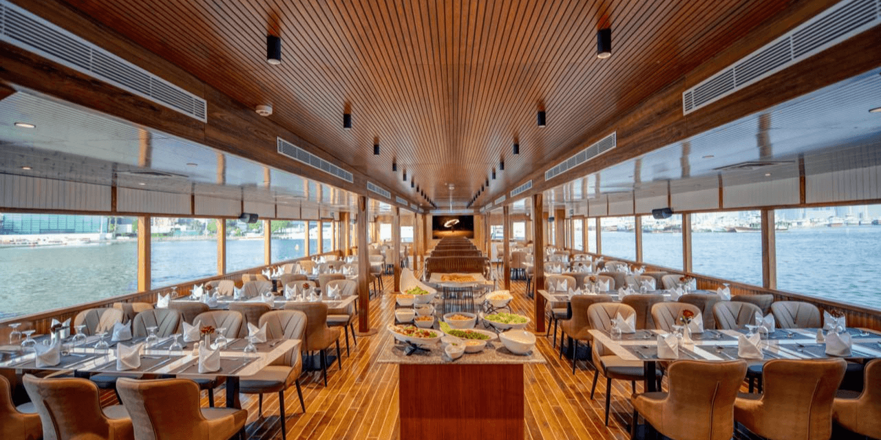 Elegant dining hall with set tables inside Celeste Marina cruise Dubai