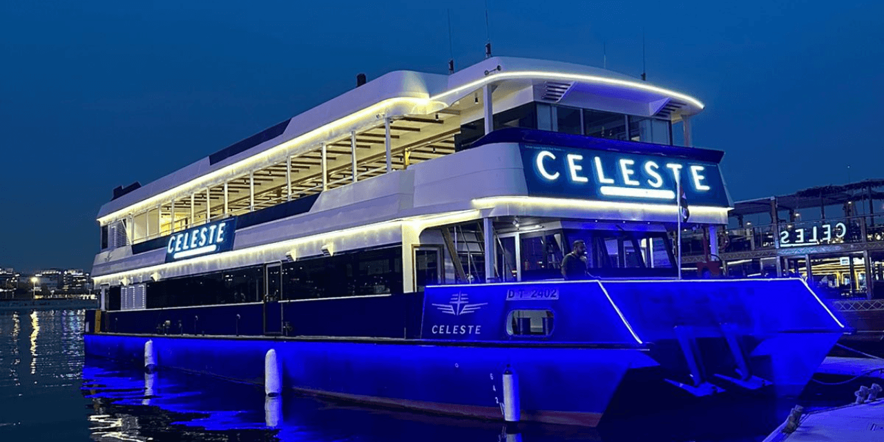 Blue lit interior of Celeste Marina dinner cruise Dubai