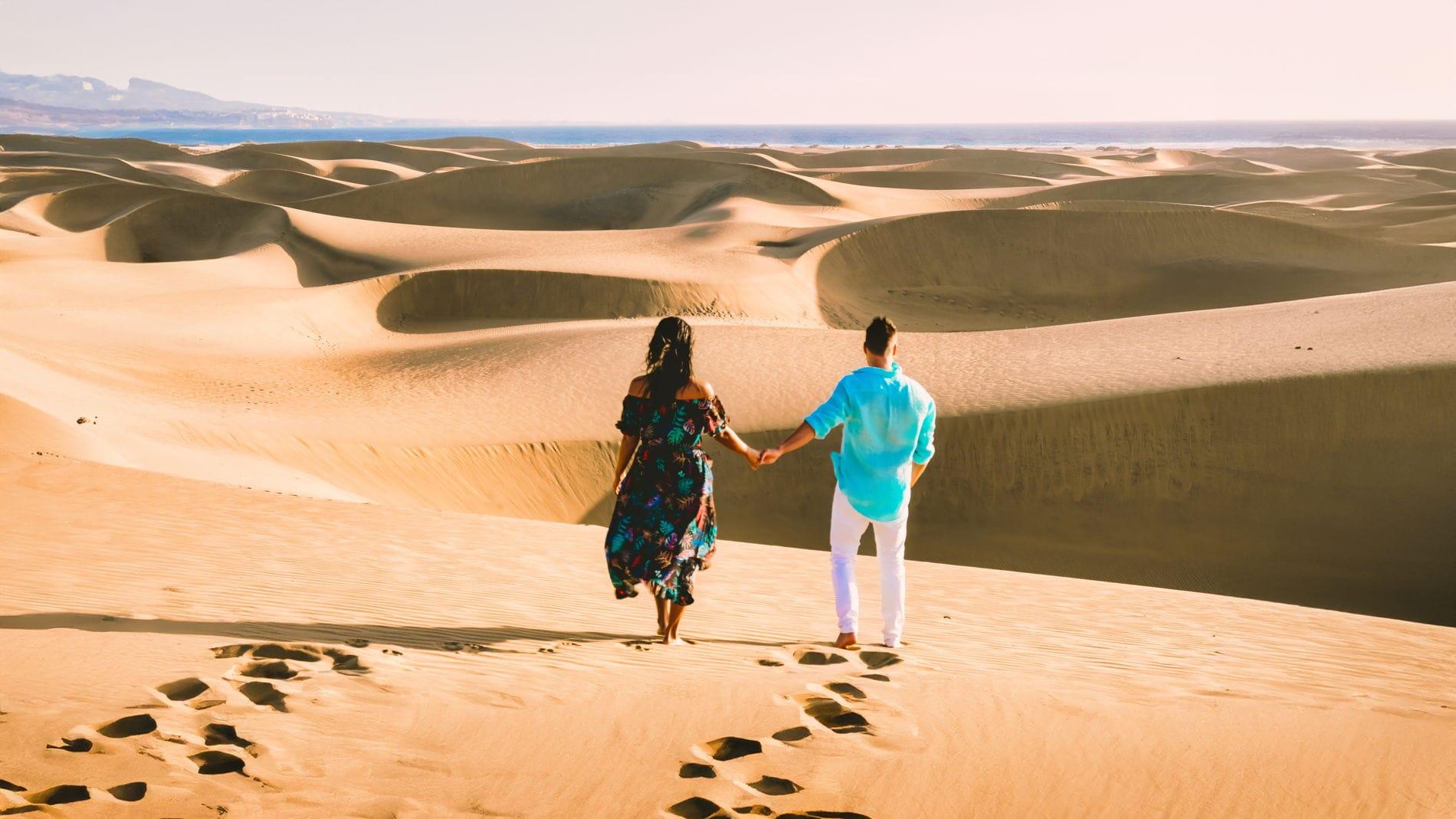Couple enjoying sunset at Dubai desert during evening safari tour
