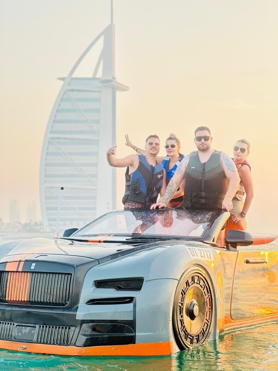 Guests enjoying jet car ride on water with Dubai skyline in background
