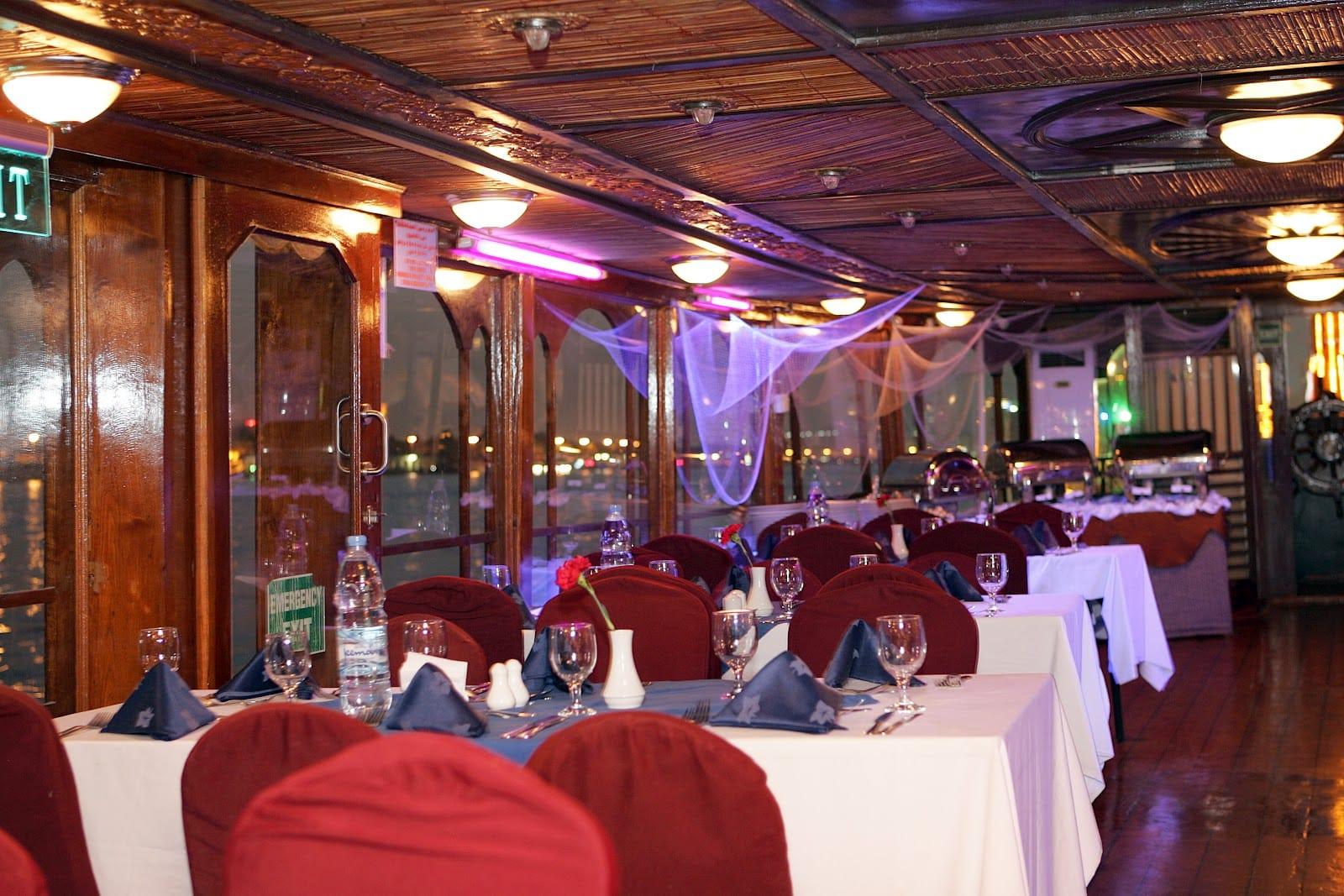 Elegant table setting inside Ocean Empress dhow cruise Dubai