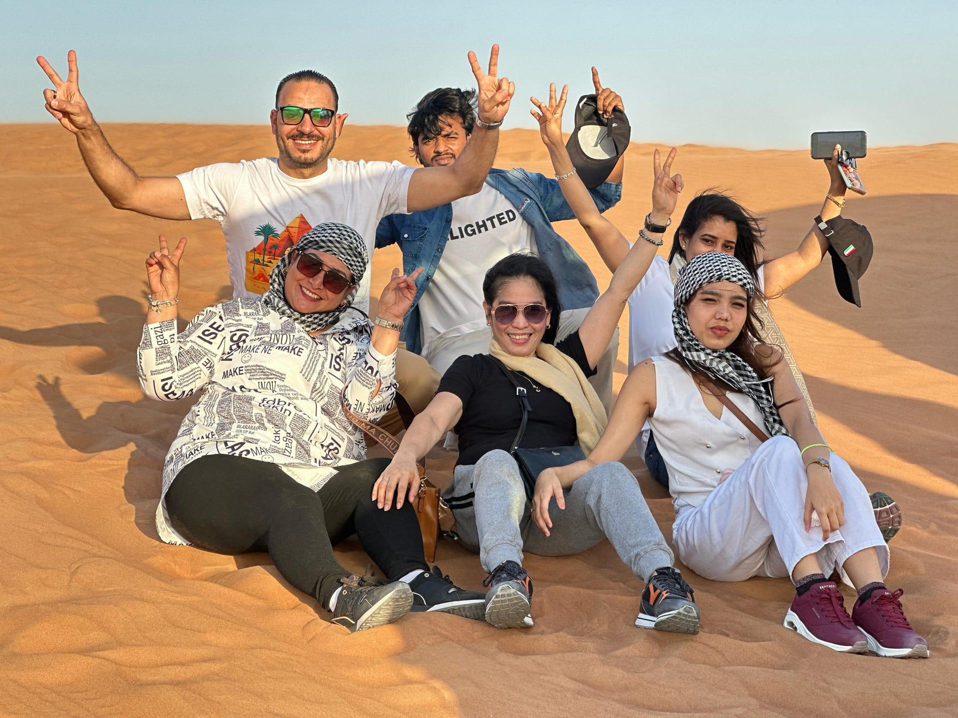 Family group photo on sand dunes during private morning safari Dubai