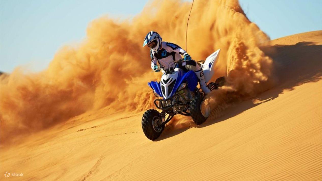 Rider on quad bike navigating Lahbab Red Dunes in Dubai