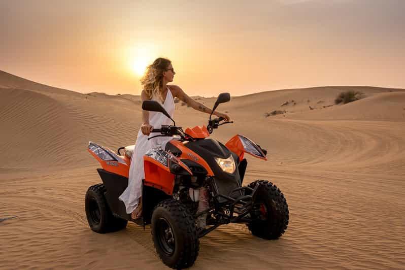 Red ATV quad bike on sand dunes during morning desert safari Dubai