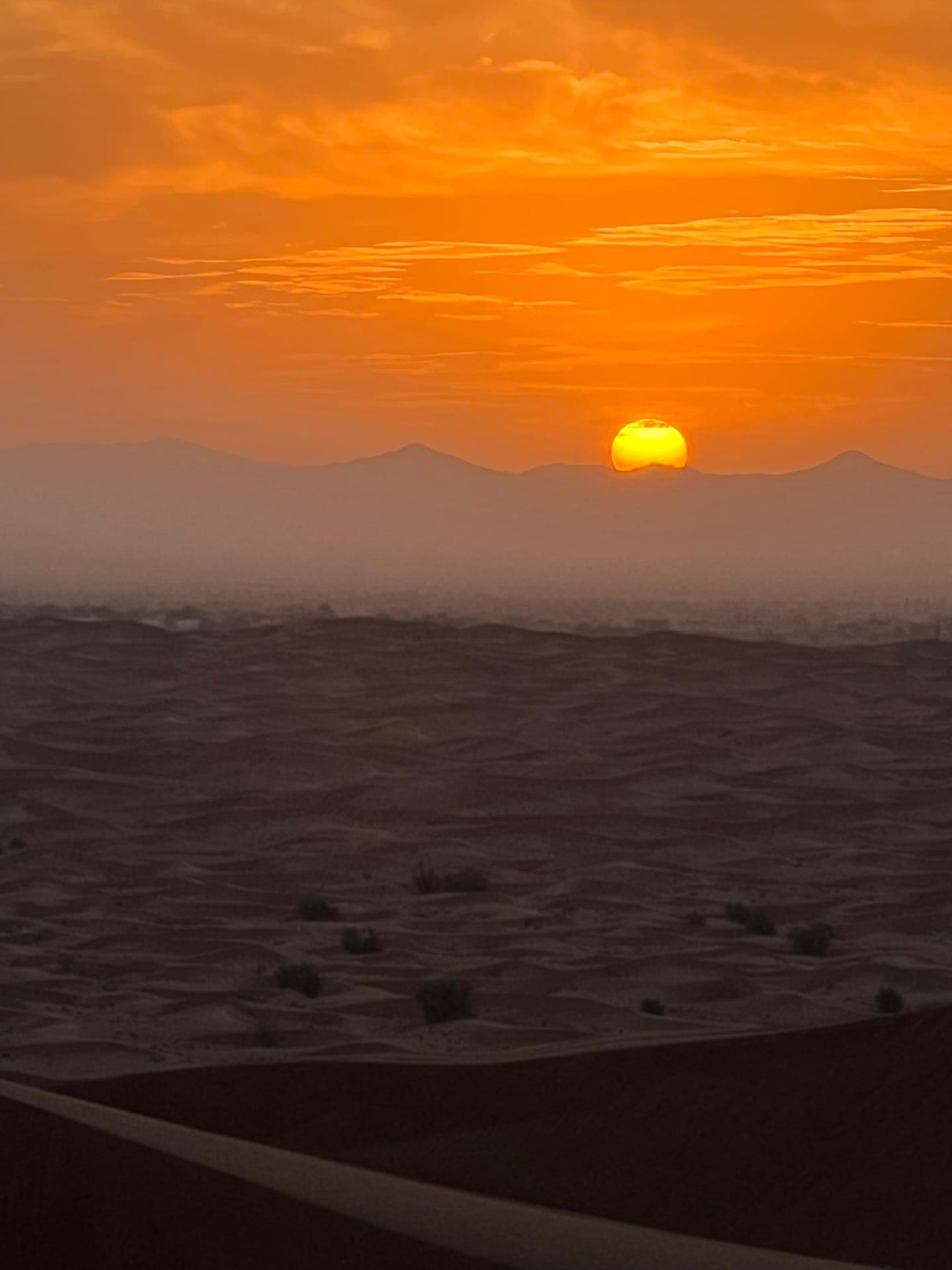 Golden sunrise over Dubai desert dunes during morning buggy safari